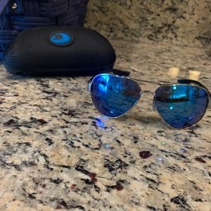 Costa sunglasses with blue polarized glass lenses.